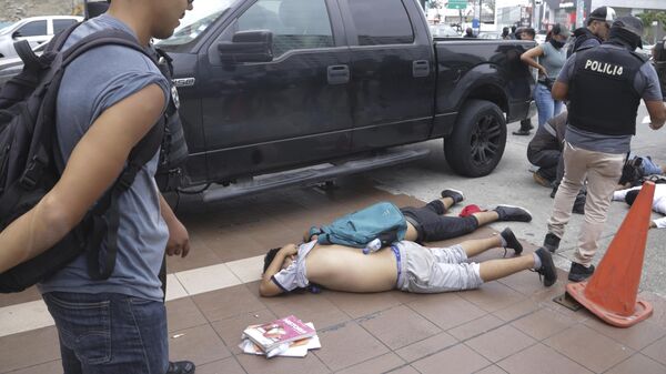 Men lie face down on the ground, detained by police outside TC Television, after a producer told police that they were part of a group who broke onto their set during a live broadcast, although they had not entered the station, in Guayaquil, Ecuador, Tuesday, Jan. 9, 2024.  - Sputnik Africa