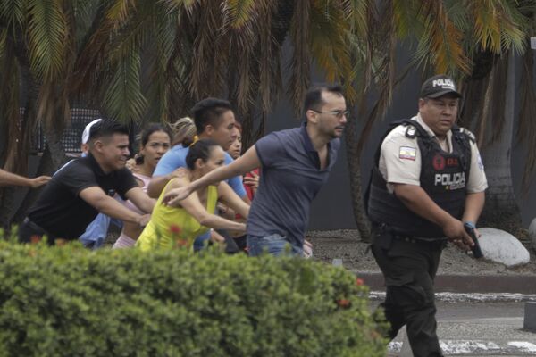 Police evacuate staff from the TC television channel station after a group of armed men broke onto their set during a live broadcast, in Guayaquil, Ecuador, Tuesday, Jan. 9, 2024. - Sputnik Africa