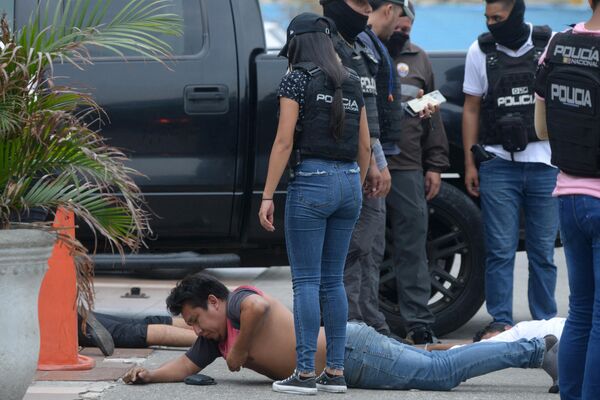 Ecuadorean police officers fuard the arrested suspects outside Ecuador&#x27;s TC television channel after unidentified gunmen burst into the state-owned television studio live on air on January 9, 2024, in Guayaquil, Ecuador, a day after Ecuadorean President Daniel Noboa declared a state of emergency following the escape from prison of a dangerous narco boss. - Sputnik Africa