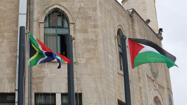 The flags of South Africa and Palestine flutter outside the municipality building in Bethlehem in the occupied West Bank on January 12, 2024, the day after South Africa launched an emergency case at the International Court of Justice (ICJ) arguing that Israel stands in breach of the UN Genocide Convention, signed in 1948 in the wake of the Holocaust.  - Sputnik Africa