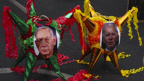 Demonstrators place pictures of Israel's Prime Minister Benjamin Netanyahu, left, and U.S. President Joe Biden on the ground during a protest against the Israel-Hamas war, outside the U.S. Embassy, in Mexico City, Sunday, Jan. 7, 2024.  - Sputnik Africa
