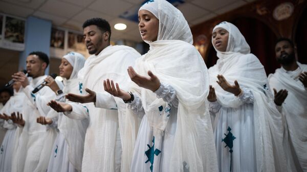 Worshipers attend a service to celebrate Timket, or the feast of Epiphany, in the Eritrean Orthodox Tewahdo church in Leeds, northern England on January 20, 2024.  - Sputnik Africa