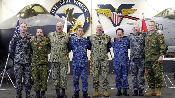 Navy officials from the four main participants of the Annualex 23 joint exercise pose for a group photo after a news conference aboard a US Navy aircraft carrier USS Carl Vinson - Sputnik Africa