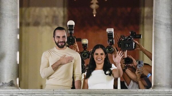 El Salvador President Nayib Bukele, left, accompanied by his wife Gabriela Rodriguez, wave to supporters from the balcony of the presidential palace in San Salvador, El Salvador, after he was re-elected to another five-year term on Sunday, Feb. 4, 2024.  - Sputnik Africa