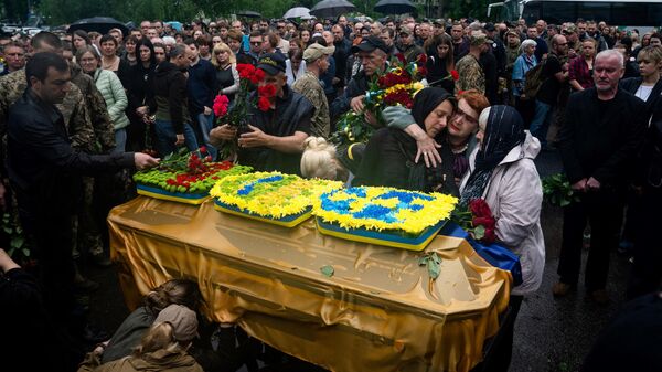 Relatives and friends take part in a funeral service of the Ukrainian Lance Sergeant Yulian Matviychuk, who died from his wounds in the Donetsk region, during funeral in Poltava, on May 23, 2023. - Sputnik Africa