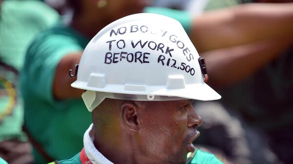 A member of the South African Association of Mineworkers and Construction Union (AMCU) takes part in a march to the Union Buildings in Pretoria on March 6, 2014, to voice grievances with the Lonmin Mines, asking for a minimum wage of R12.500 (1175 USD). - Sputnik Africa
