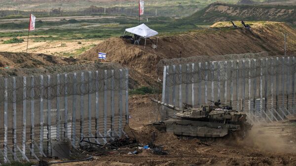 This picture taken from a position in southern Israel near the border with the Gaza Strip shows an Israeli battle tank crossing the border into northern Gaza on February 19, 2024, amid the ongoing battles between Israel and the Palestinian militant group Hamas. - Sputnik Africa