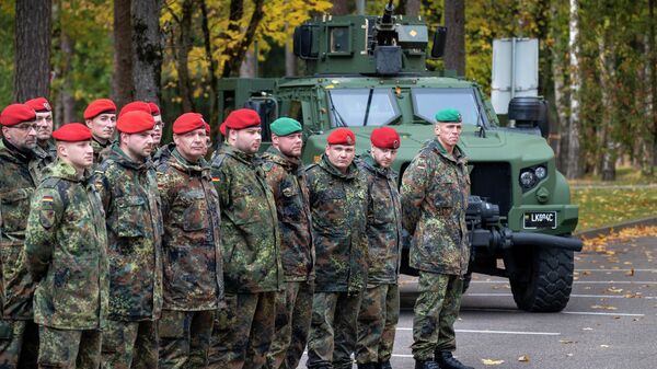 Soldiers of the German Bundeswehr 41st Mechanized Infantry Brigade Forward Command Element wait to greet German Defense Minister Christine Lambrecht upon her arrival at the Rukla military base some 100 kms (62.12 miles) west of the capital Vilnius, Lithuania, Saturday, Oct. 8, 2022. - Sputnik Africa