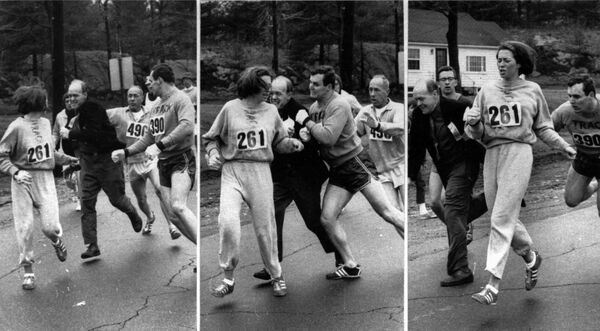 A woman, listed only as K. Switzer of Syracuse, found herself about to be thrown out of the normally all-male Boston Marathon when a husky companion, Thomas Miller of Syracuse, threw a block that tossed a race official out of the running instead, April 19, 1967 in Hopkinton, Mass. - Sputnik Africa