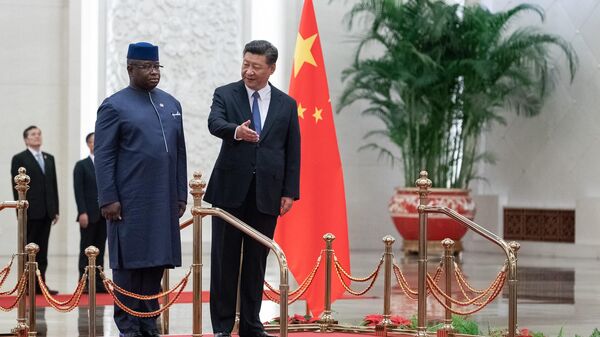 China's President Xi Jinping (R) shows the way to Sierra Leone President Julius Maada Bio (L) during the welcome ceremony at the Great Hall of the People in Beijing on August 30, 2018.  - Sputnik Africa