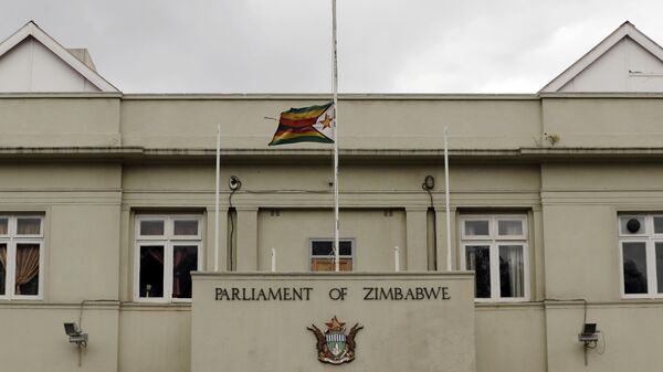 The Zimbabwean flag flies at half-mast at the parliament building in Harare, Zimbabwe, Saturday, Sept. 7, 2019.  - Sputnik Africa