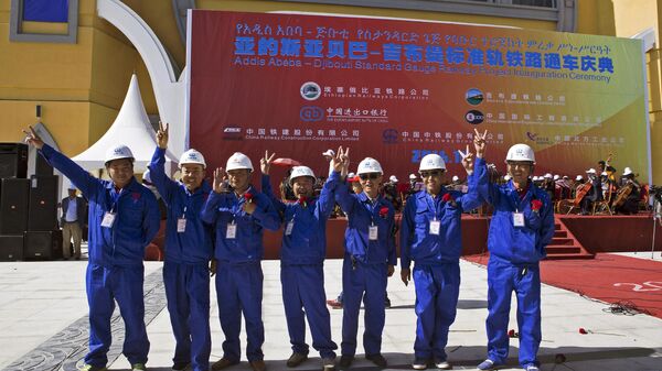 Chinese workers pose at the inauguration site of a train linking Addis Ababa to Djibouti, 20 kilometers from the center of Addis Ababa on October 5, 2016. - Sputnik Africa