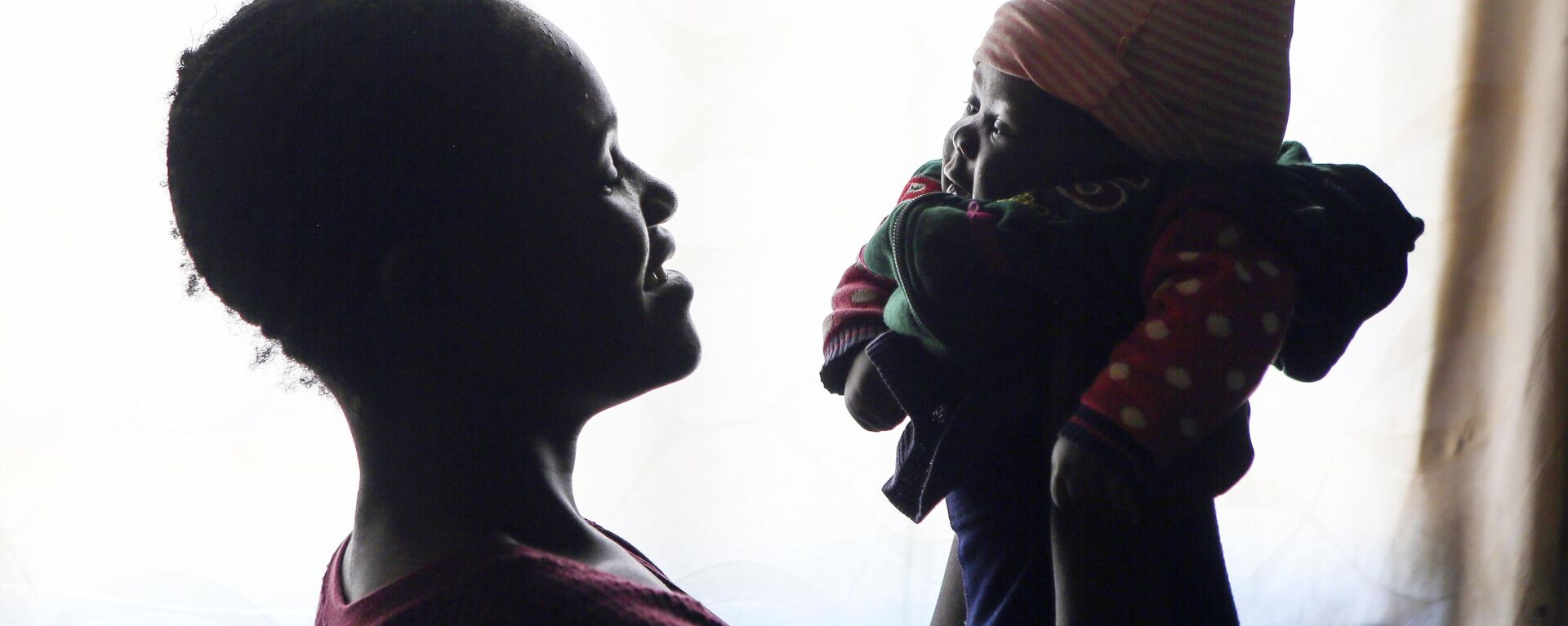 Virginia Mavhunga, a 13-year-old teenage mother, plays with her child at her rural home in Murehwa, 80 kilometres (50 miles)  northeast of Zimbabwe's capital Harare, Friday, Dec. 10, 2021. - Sputnik Africa, 1920, 14.03.2024