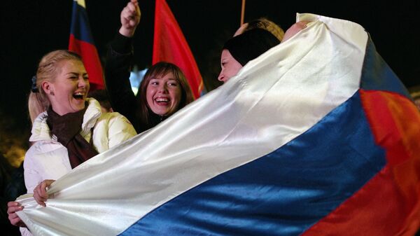 Residents of Russian city Sevastopol during a festive concert in honor of the reunification of Crimea with Russia - Sputnik Africa