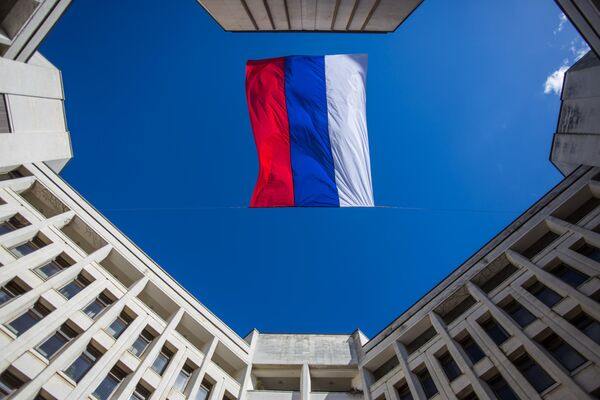 The flag of Russia over the building of the Supreme Council of the Autonomous Republic of Crimea in Simferopol, where an extraordinary plenary session of the parliament decided on the independence of the autonomy. - Sputnik Africa