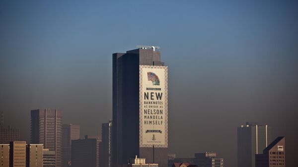 A giant sign hangs on a building advertising a series of banknotes featuring the image of former President Nelson Mandela issued by the South African Reserve Bank, above the skyline in Pretoria, where Mandela is being treated, in South Africa Wednesday, June 12, 2013. - Sputnik Africa