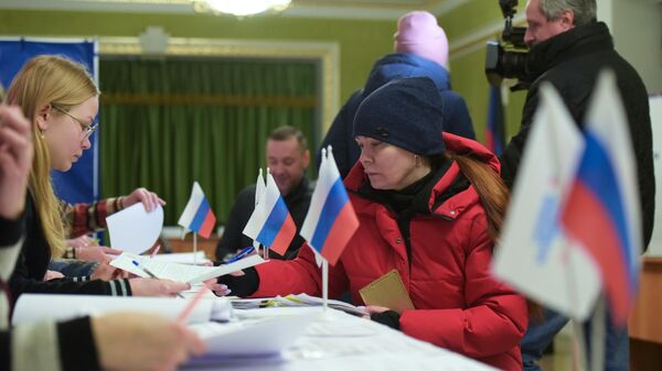 People vote in the Russian presidential election at a polling station in Donetsk. - Sputnik Africa