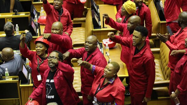 Members of the opposition Economic Freedom Fighters (EFF) party object as South African President Cyril Ramaphosa attempts to deliver his State of the Nation address at parliament in Cape Town on February 13, 2020. - Sputnik Africa