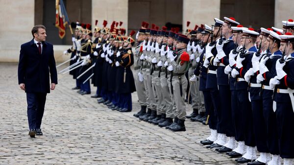 French President Emmanuel Macron reviews troops during a Prise d'armes military ceremony in the courtyard of the Hotel National des Invalides in Paris, on February 19, 2024.  - Sputnik Africa