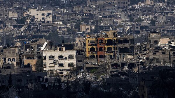 Destroyed buildings stand inside the Gaza Strip, as seen from southern Israel, Tuesday, March 19, 2024.  - Sputnik Africa