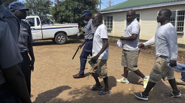 Ishmael Chokurongerwa , 56, in blue flip flops a self styled prophet arrives for his court appearance accompanied by his aides in Norton about 40 kilometres west of the capital, Harare - Sputnik Africa