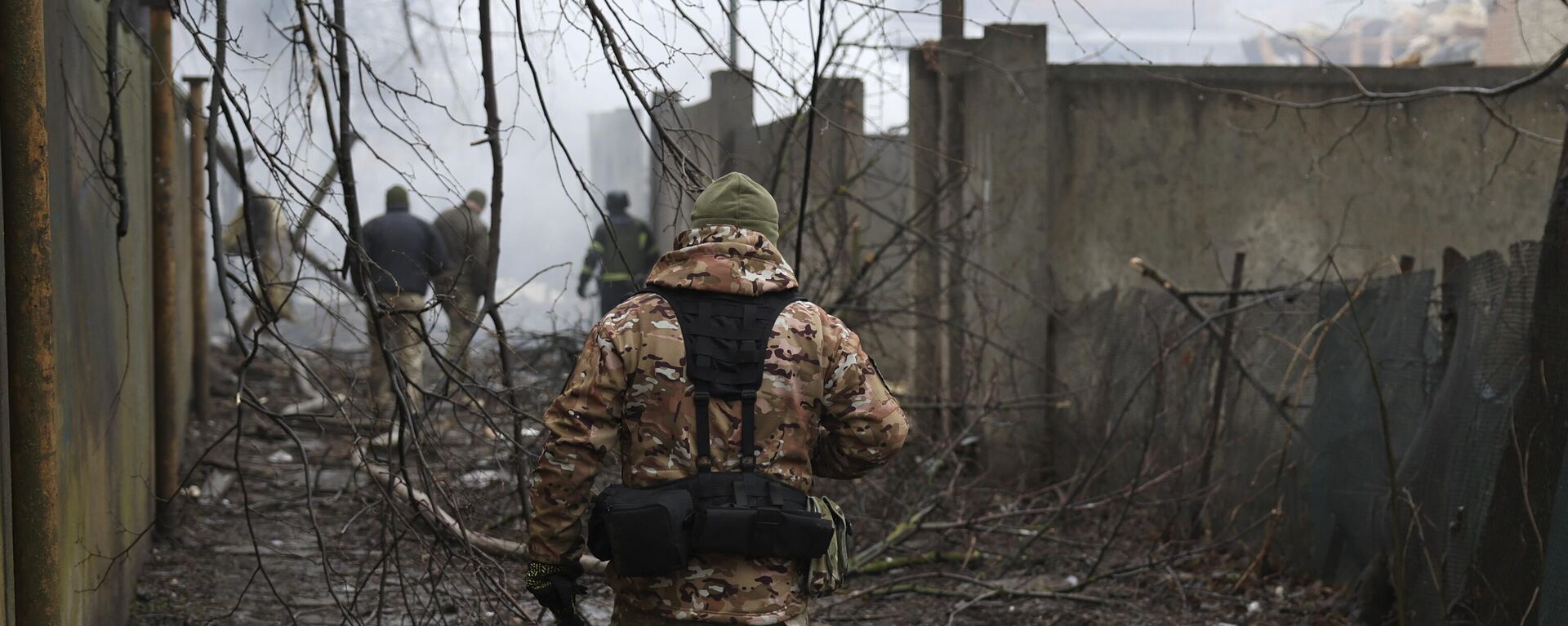 A member of the Ukrainian military walks near the scene of a Russian attack in Odessa, Ukraine, Friday March 15, 2024.  - Sputnik Africa, 1920, 23.08.2024