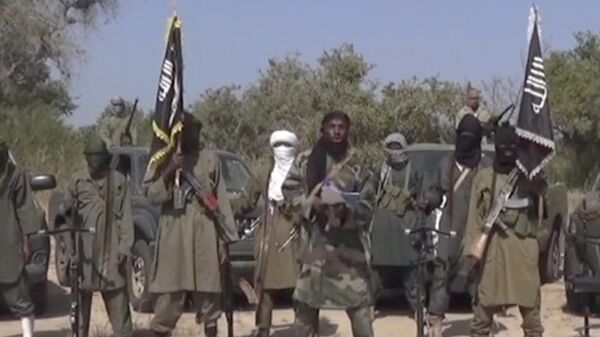 This Friday Oct. 31, 2014 image taken from video by Nigeria's Boko Haram terrorist network, the leader of Nigeria's Islamic extremist group Boko Haram, center, has denied agreeing to any cease-fire with the government and said Friday more than 200 kidnapped schoolgirls all have converted to Islam and been married off. - Sputnik Africa