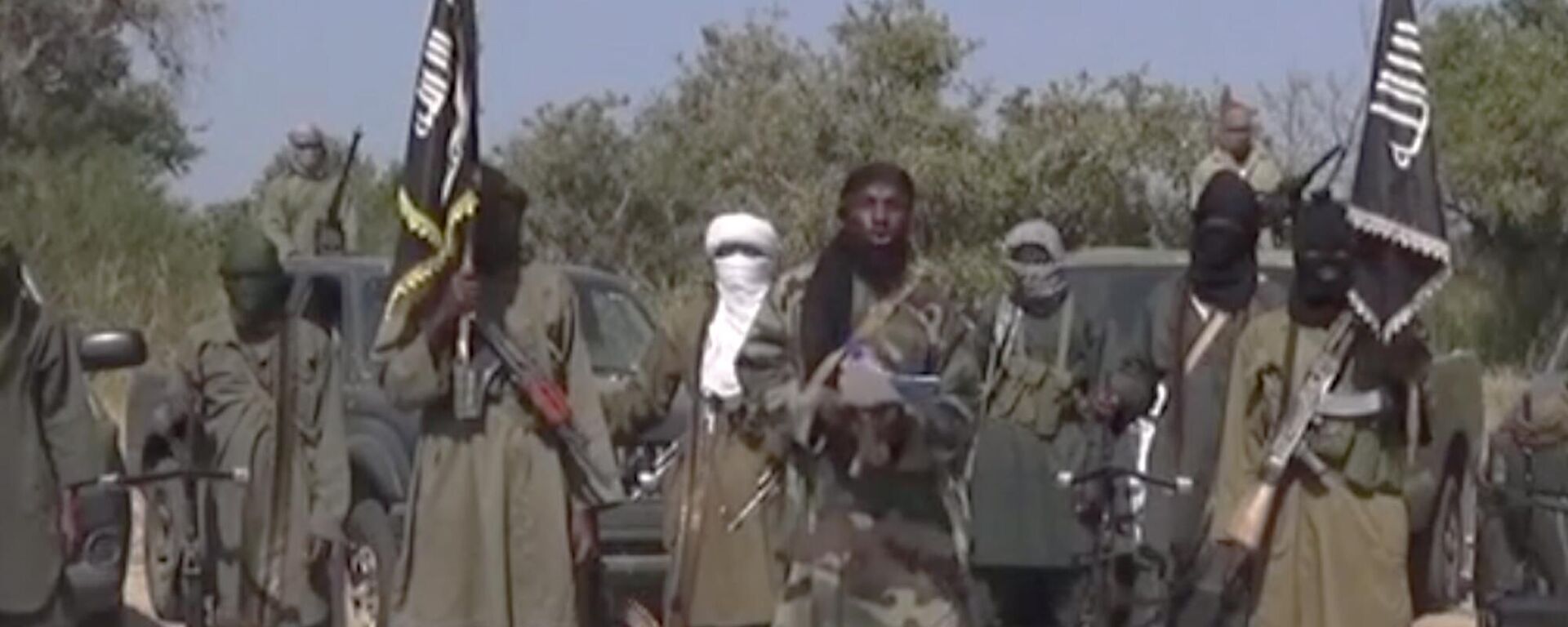 This Friday Oct. 31, 2014 image taken from video by Nigeria's Boko Haram terrorist network, the leader of Nigeria's Islamic extremist group Boko Haram, center, has denied agreeing to any cease-fire with the government and said Friday more than 200 kidnapped schoolgirls all have converted to Islam and been married off. - Sputnik Africa, 1920, 29.03.2024