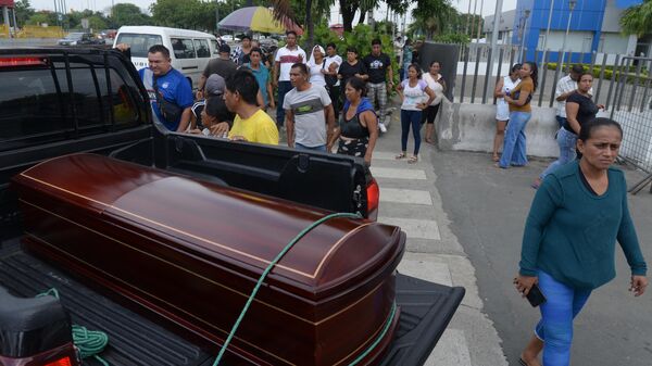 Relatives morn next to the coffin of one of the victims of the eve shooting at a cooperative, after the bodies were released from the Crime and Forensic Sciences Laboratory, in Guayaquil, Ecuador, on March 31, 2024. - Sputnik Africa