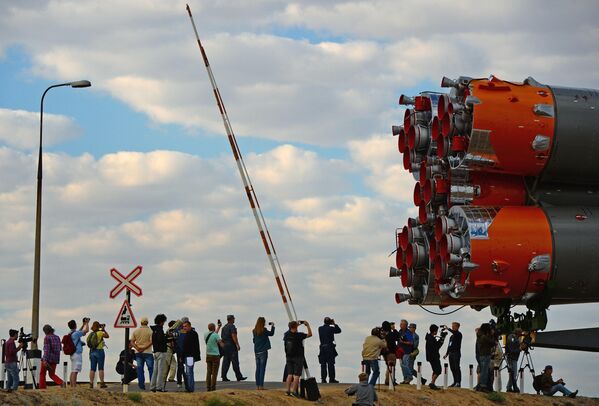 Journalists photograph the Russian Soyuz-FG launch vehicle with the Soyuz TMA-18 M manned transport vehicle during its removal to the launch pad of the country&#x27;s Baikonur cosmodrome. - Sputnik Africa