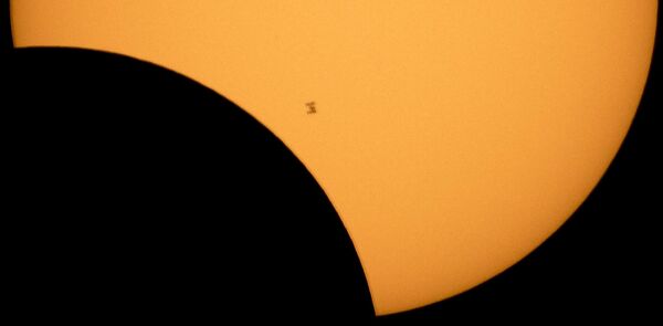 The International Space Station is silhouetted against the sun during a partial solar eclipse Monday, August 21, 2017. - Sputnik Africa