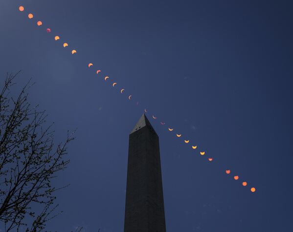This composite image of multiple exposures shows the progression of a partial solar eclipse over the Washington Monument, Monday, April 8, 2024, in Washington. - Sputnik Africa