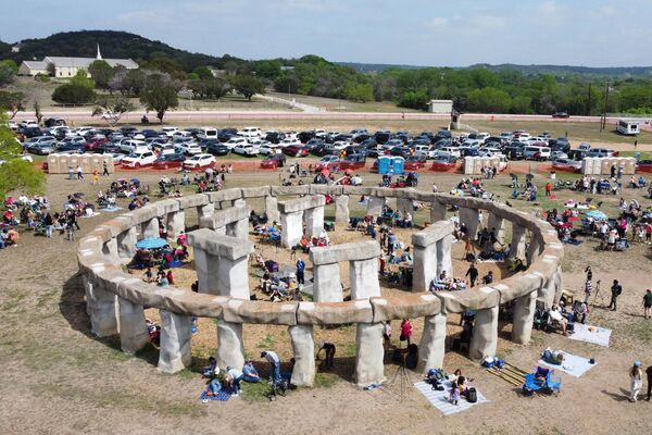 People gather to watch a total solar eclipse across North America, at Stonehenge II at the Hill Country Arts Foundation in Ingram, Texas, on April 8, 2024. This year&#x27;s totality is 115 miles (185 kilometers) wide and home to nearly 32 million Americans, with an additional 150 million living less than 200 miles from the strip. The next total solar eclipse that can be seen from a large part of North America won&#x27;t come around until 2044.  - Sputnik Africa