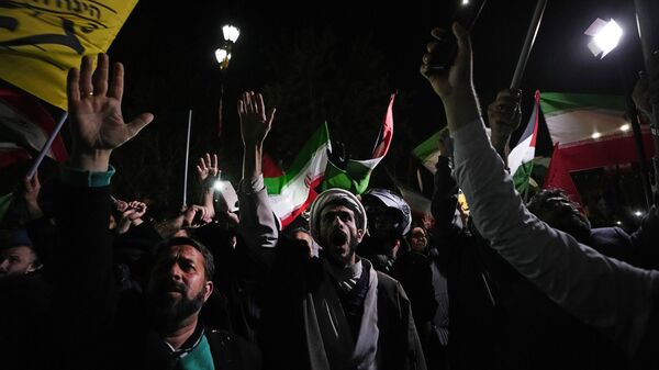 Iranian demonstrators chant slogans during an anti-Israeli gathering in front of the British Embassy in Tehran, Iran, early Sunday, April 14, 2024. Iran launched its first direct military attack against Israel on Saturday. - Sputnik Africa