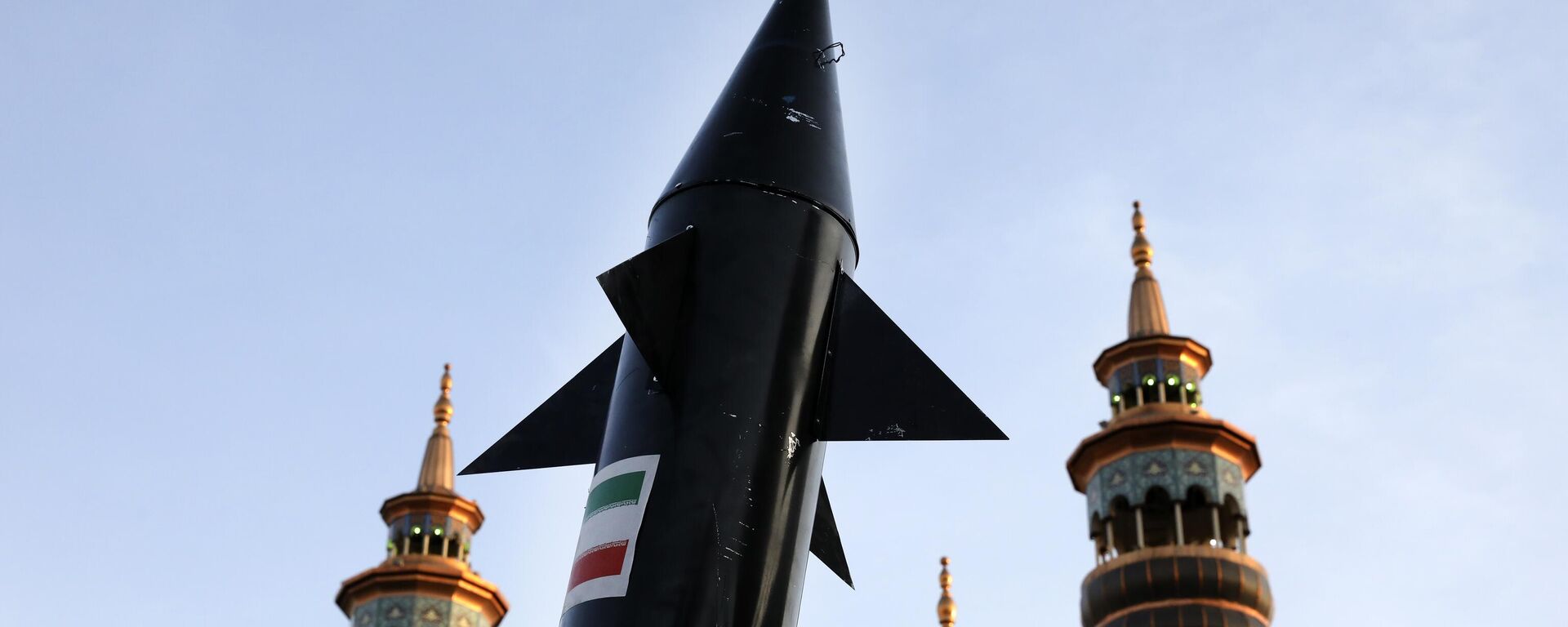 A model of a missile is carried by Iranian demonstrators as minarets and dome of a mosque is seen at background during an anti-Israeli gathering at the Felestin (Palestine) Sq. in Tehran, Iran, Monday, April 15, 2024. - Sputnik Africa, 1920, 02.10.2024