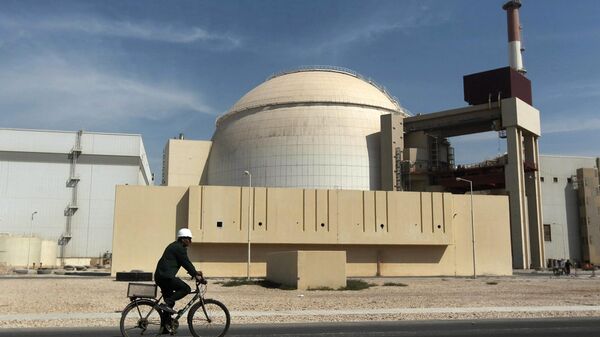 A worker rides a bicycle in front of the reactor building of the Bushehr nuclear power plant, just outside the southern city of Bushehr, Iran, Oct. 26, 2010. - Sputnik Africa