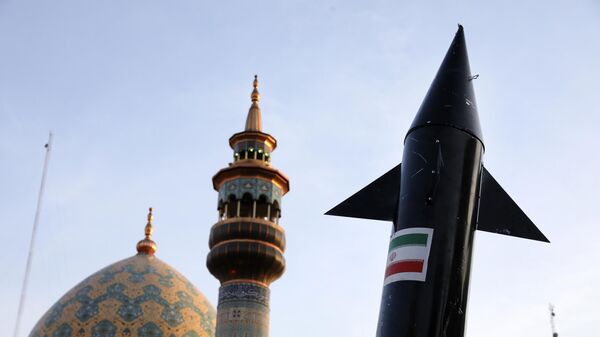 A model of a missile is carried by Iranian demonstrators as a minaret and dome of a mosque is seen at background during an anti-Israeli gathering at the Felestin (Palestine) Sq. in Tehran, Iran - Sputnik Africa