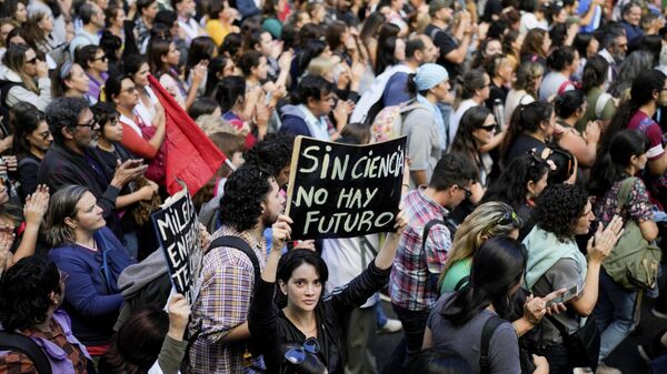 A student holds a sign that reads in Spanish Without science there's no future during a march for more funding for public universities and against austerity measures proposed by President Javier Milei in Buenos Aires, Argentina, Tuesday, April 23, 2024. - Sputnik Africa