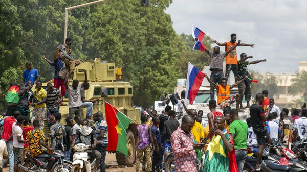 Supporters of Capt. Ibrahim Traore cheer with Russian flags in the streets of Ouagadougou, Burkina Faso, Sunday, Oct. 2, 2022. - Sputnik Africa