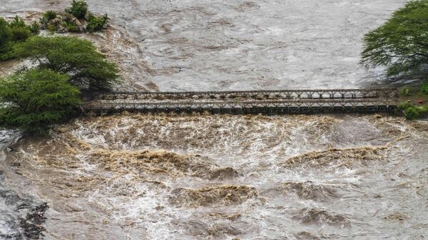 Flood waters cover a bridge in the flooded Maasai Mara National Reserve, that left dozens of tourists stranded in Narok County, Kenya, Wednesday, May 1, 2024. - Sputnik Africa
