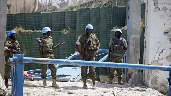 United Nations soldiers stand in front of the destroyed gate outside the UN's office in Mogadishu, Somalia, Tuesday, July, 26, 2016. - Sputnik Africa