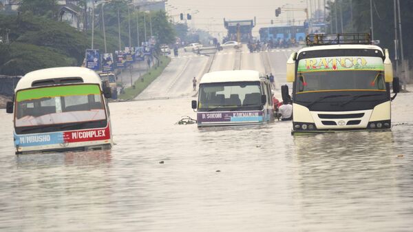 Public minibus are submerged in the flooded streets of Dar salaam, Tanzania Thursday, April 25, 2024. - Sputnik Africa
