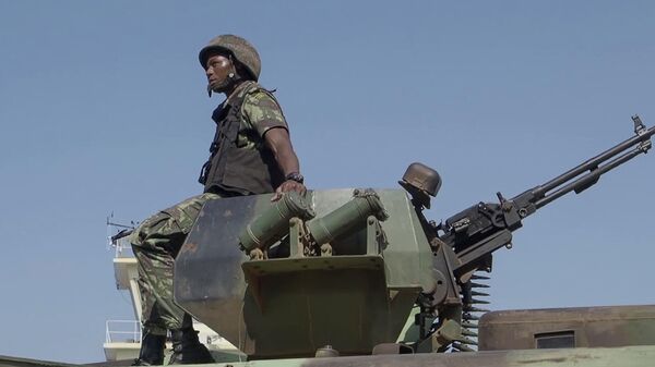 In this image made from video, a Mozambican soldier rides on an armored vehicle at the airport in Mocimboa da Praia, Cabo Delgado province, Mozambique, Aug. 9, 2021. - Sputnik Africa