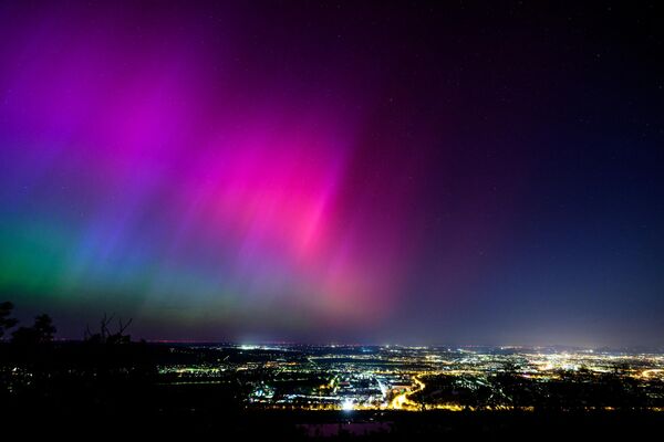 Northern lights or aurora borealis illuminate the night sky over Vienna during a geomagnetic storm on May 11, 2024. - Sputnik Africa