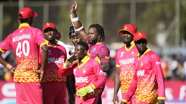 West Indies batsman Kyle Mayers raises his hand during their ICC Men's Cricket World Cup Qualifier match against Zimbabwe at Harare Sports Club in Harare, Zimbabwe, Saturday June, 24, 2023.  - Sputnik Africa