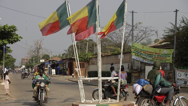 People ride past Benin's national flags in Ouidah, Benin, on Wednesday, Jan. 9, 2013. - Sputnik Africa