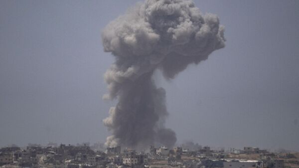 Smoke billows after an explosion in the Gaza Strip, as seen from southern Israel Tuesday, May 21, 2024.  - Sputnik Africa