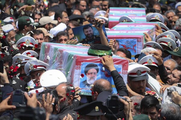 In this photo released by the Iranian Presidency Office, flag-draped coffins of President Ebrahim Raisi and his companions, who were killed in a helicopter crash on Sunday, are carried during their funeral ceremony in the city of Mashhad, Iran, Thursday, May 23, 2024. - Sputnik Africa