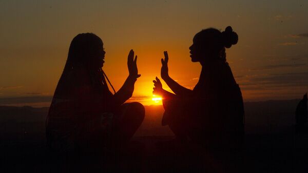 Two girls have fun while playing on top of a hill at sunset on Africa Day in Harare, Tuesday, May, 25, 2021. - Sputnik Africa