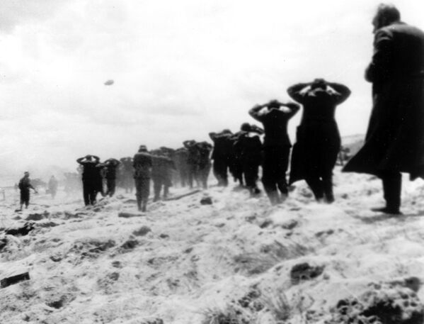 German prisoners of war are led away by Allied forces from Utah Beach, near Sainte-Mere-Eglise, on June 6, 1944, during landing operations on the Normandy coast, France.(AP Photo, File) - Sputnik Africa